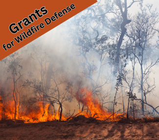 image of wildfire with text grants for wildfire defense